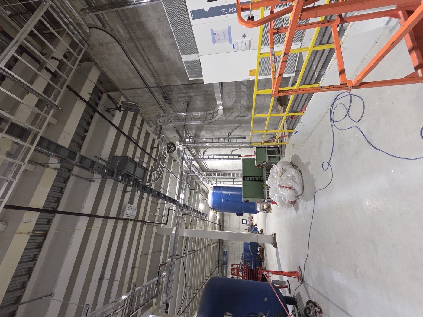 Mechanical room with tanks and conduit