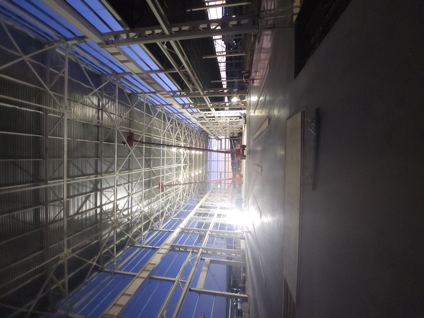 Warehouse shell at dusk with a boom lift