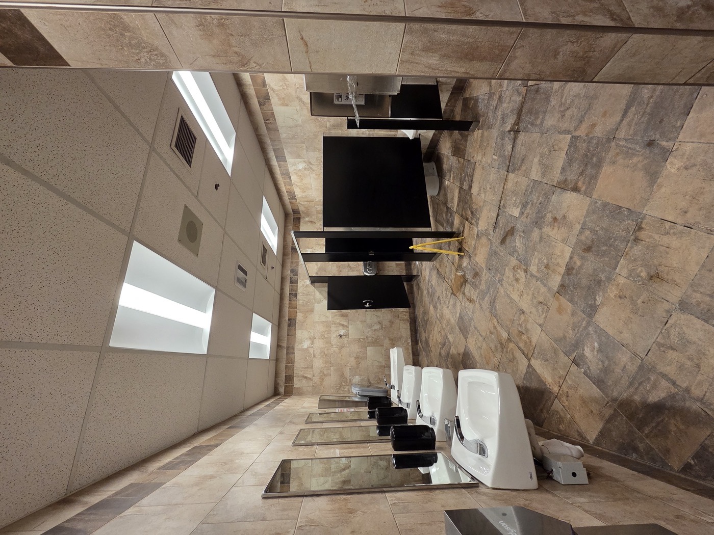 Renovated washroom with sinks and partitions