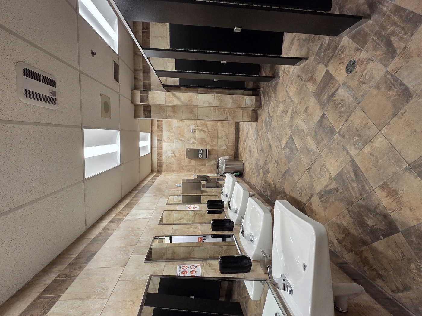 Renovated school washroom with new sinks and mirrors