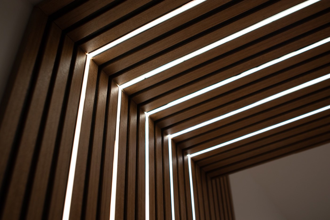 Walnut slat wall with integrated lines of light