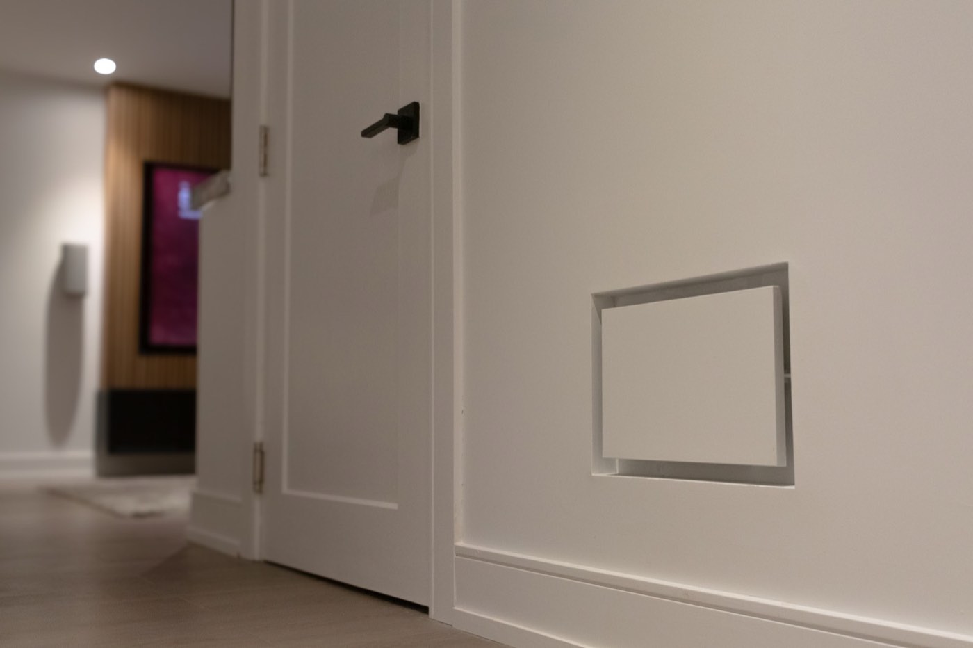 Lit stone niche set into a walnut wall