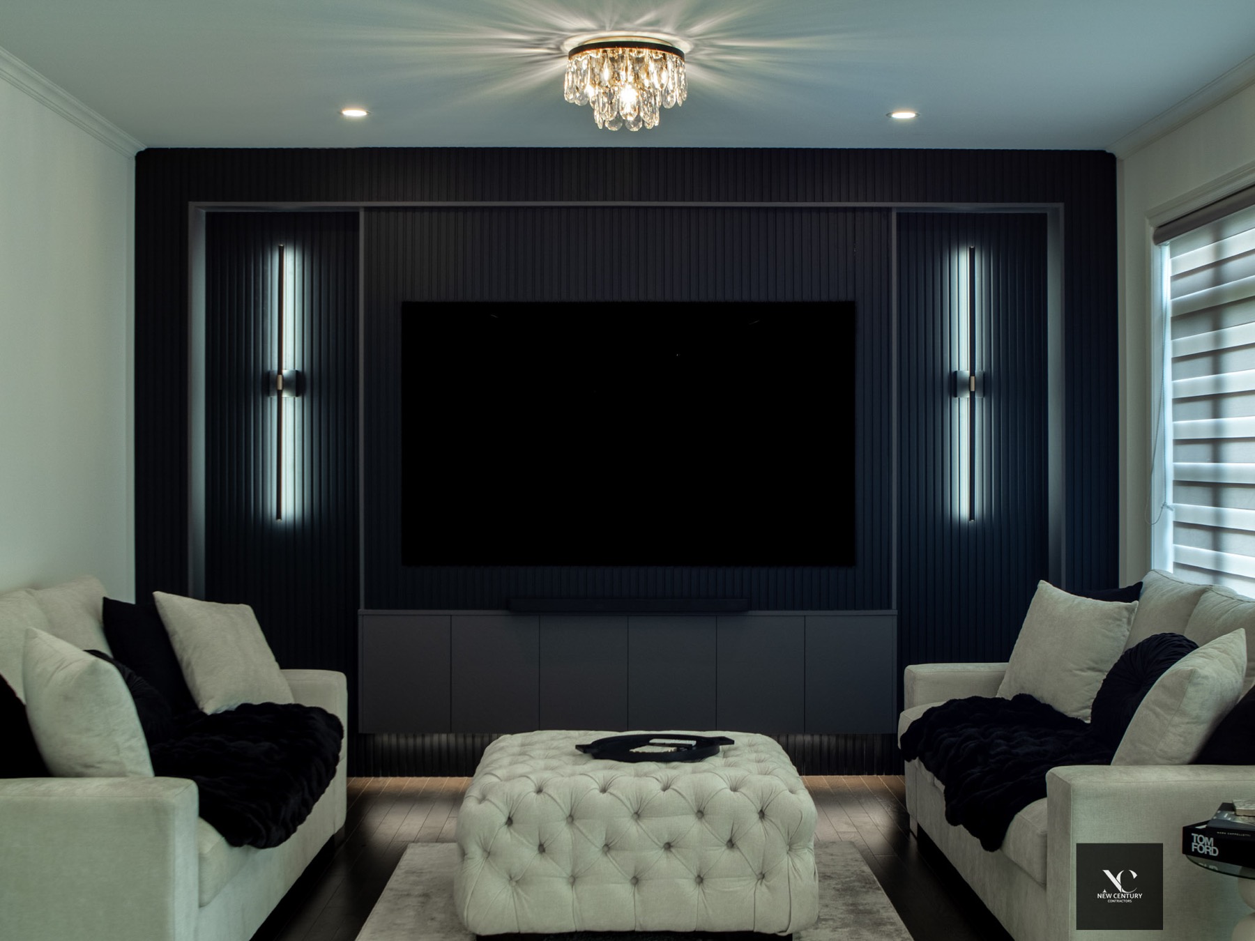 Media room with black slat wall, vertical sconces and crystal flush mount